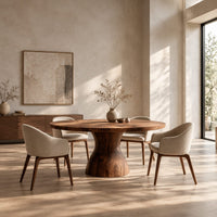 Round dining table with an hourglass pedestal base in a bright open plan dining room