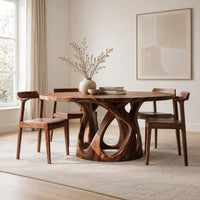 Round dining table on an open base of interlaced curves in a Scandinavian dining room with white walls