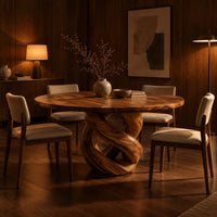 Round dining table with a twisted loop pedestal base in an evening dining room with walnut wall paneling