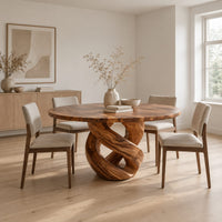 Round dining table with a twisted loop pedestal base in a Scandinavian dining room with white walls