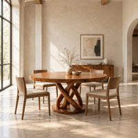 Round dining table with an interwoven wood loop base in a bright open plan dining room