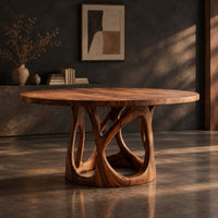 Circular dining table with an openwork branch pedestal base, three-quarter view showing the grain