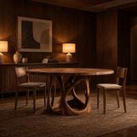 Circular dining table with an openwork branch pedestal base in an evening dining room with walnut wall paneling