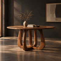 Round dining table with a thick pedestal base of arched wooden loops, three-quarter view showing the grain
