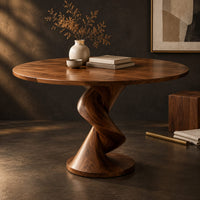 Corner detail of circular dining table with a twisted pedestal base on a disc foot beside wood, brass and linen samples