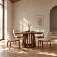 Circular dining table with a slatted drum pedestal base in a bright open plan dining room