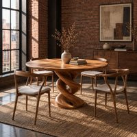 Round dining table with a twisted spiral pedestal and a flat disc foot in an industrial loft dining room with exposed brick