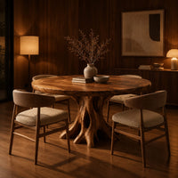 Circular dining table on a hollow tree trunk pedestal with spreading roots in an evening dining room with walnut wall paneling