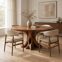 Circular dining table on a hollow tree trunk pedestal with spreading roots in a Scandinavian dining room with white walls
