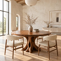 Circular dining table on a hollow tree trunk pedestal with spreading roots in a bright open plan dining room