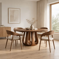 Circular dining table on a tulip shaped ring of arched legs in a Scandinavian dining room with white walls