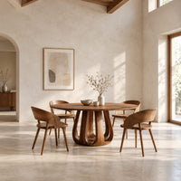 Circular dining table on a tulip shaped ring of arched legs in a bright open plan dining room