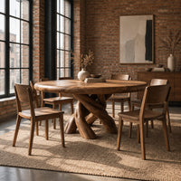 Round dining table with a twisted branch pedestal base in an industrial loft dining room with exposed brick