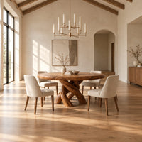 Round dining table with a twisted branch pedestal base in a bright open plan dining room