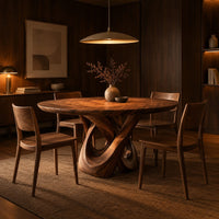 Round dining table with a twisted loop pedestal base in an evening dining room with walnut wall paneling