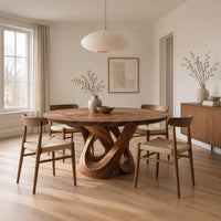 Round dining table with a twisted loop pedestal base in a Scandinavian dining room with white walls