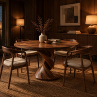 Round dining table with a twisted pedestal and disc base in an evening dining room with walnut wall paneling