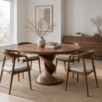 Round dining table with a twisted pedestal and disc base in a Scandinavian dining room with white walls