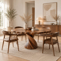 Circular dining table with twisted pedestal base and rippled edge in a Scandinavian dining room with white walls