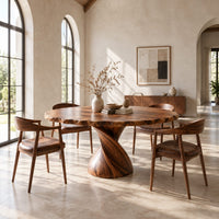 Circular dining table with twisted pedestal base and rippled edge in a bright open plan dining room