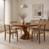 Round dining table on a single twisted pedestal in a Scandinavian dining room with white walls