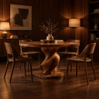 Round dining table with a spiral twisted pedestal on a thick disc base in an evening dining room with walnut wall paneling