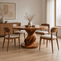 Round dining table with a spiral twisted pedestal on a thick disc base in a Scandinavian dining room with white walls