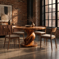 Round dining table with a spiral twisted pedestal on a thick disc base in an industrial loft dining room with exposed brick