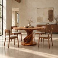 Round dining table with a spiral twisted pedestal on a thick disc base in a bright open plan dining room