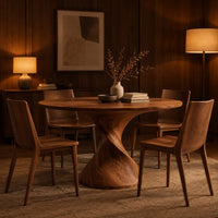 Round dining table on a twisted spiral pedestal in an evening dining room with walnut wall paneling