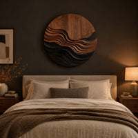 Round wall art with stepped wave ridges in two tones above a bed in a dusk lit bedroom