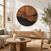 Round wall art with stepped wave ridges in two tones in a bright sunroom with green plants