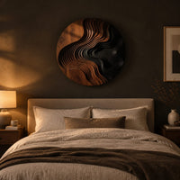 Round wall art with layered wave ridges and a dark hollow above a bed in a dusk lit bedroom