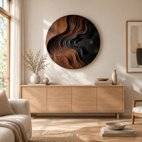 Round wall art with layered wave ridges and a dark hollow above a light oak sideboard in daylight