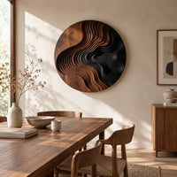 Round wall art with layered wave ridges and a dark hollow beside a dining table in natural light