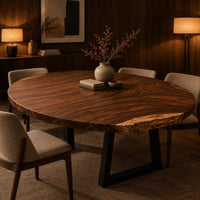 Circular wood table top with swirling grain and one natural edge in an evening dining room with walnut wall paneling