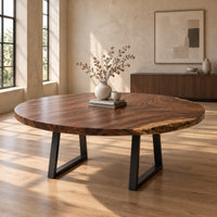 Circular wood table top with swirling grain and one natural edge in a bright open plan dining room