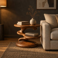 Circular side table with a spiral stem, middle shelf disc and wide base in a dark living room at golden hour