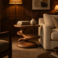 Circular side table with a spiral stem, middle shelf disc and wide base in an evening living room with walnut wall paneling
