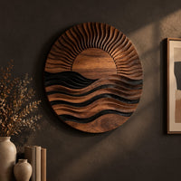 Round wall art of a sun setting over layered waves, three-quarter view showing the carved depth