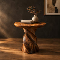 Side table with a circular top on a twisted spiral pedestal in a dark studio against a charcoal plaster wall