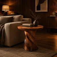 Side table with a circular top on a twisted spiral pedestal in an evening living room with walnut wall paneling