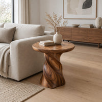 Side table with a circular top on a twisted spiral pedestal in a Scandinavian living room with white walls