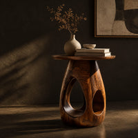 Round side table with teardrop cutouts in a pear shaped pedestal, three-quarter view showing the grain