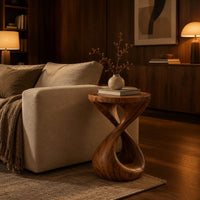 Side table with a circular top and a twisted figure eight pedestal base in an evening living room with walnut wall paneling