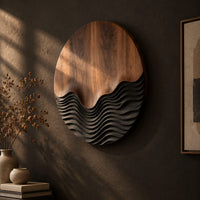 Circular wood wall art with smooth grain above dark carved wave ridges, three-quarter view showing the carved depth