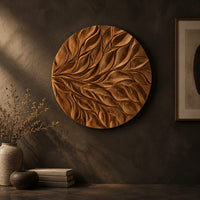 Circular wall art panel carved with sweeping layered leaves on a dark charcoal plaster wall