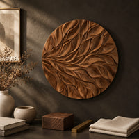Detail of circular wall art panel carved with sweeping layered leaves beside wood, brass and linen samples