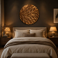 Circular wall art panel carved with sweeping layered leaves above a bed in a dusk lit bedroom