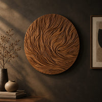 Round wooden wall relief with swirling carved ridges, three-quarter view showing the carved depth